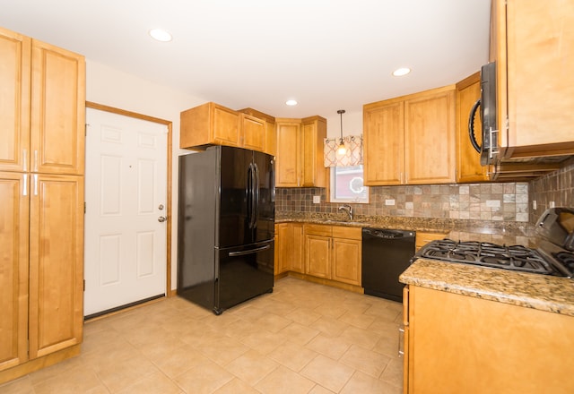 kitchen with sink, black appliances, light stone counters, decorative light fixtures, and backsplash