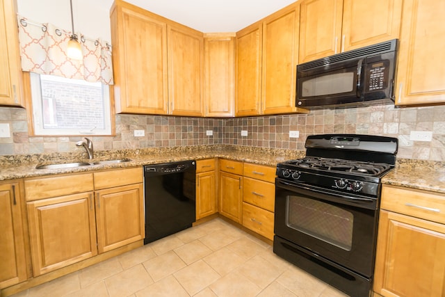 kitchen featuring black appliances, sink, tasteful backsplash, and light stone countertops