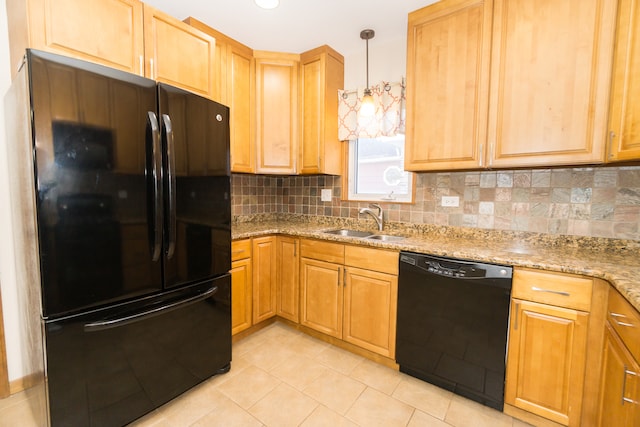 kitchen with sink, black appliances, light stone counters, backsplash, and decorative light fixtures