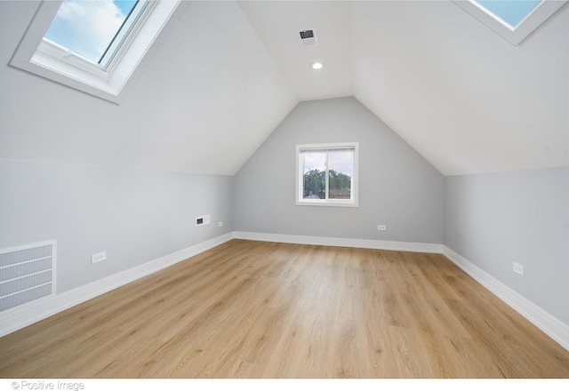 bonus room with light wood-type flooring and lofted ceiling