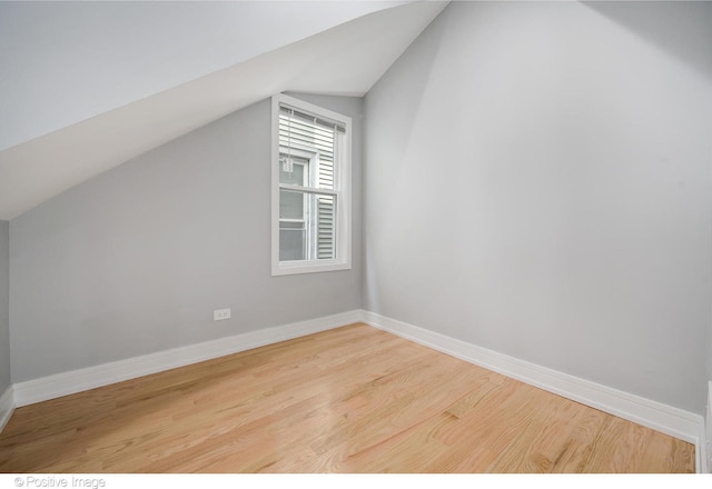 bonus room with lofted ceiling and hardwood / wood-style floors