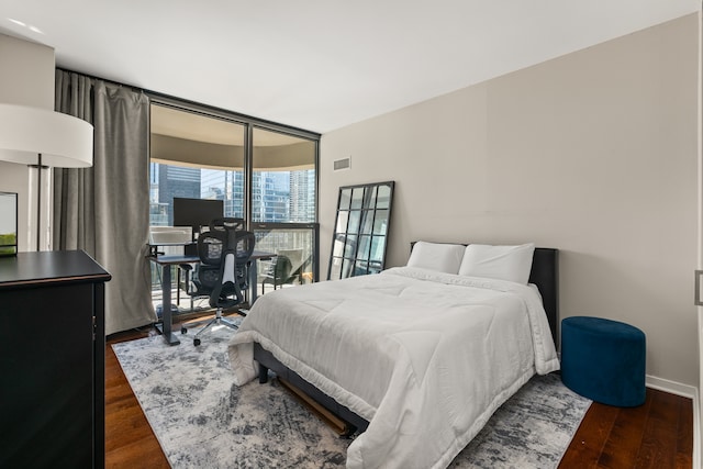 bedroom with dark hardwood / wood-style flooring