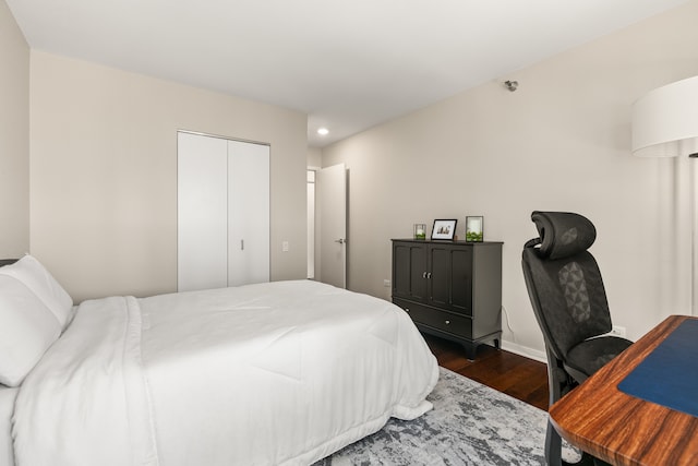 bedroom with a closet and dark hardwood / wood-style flooring