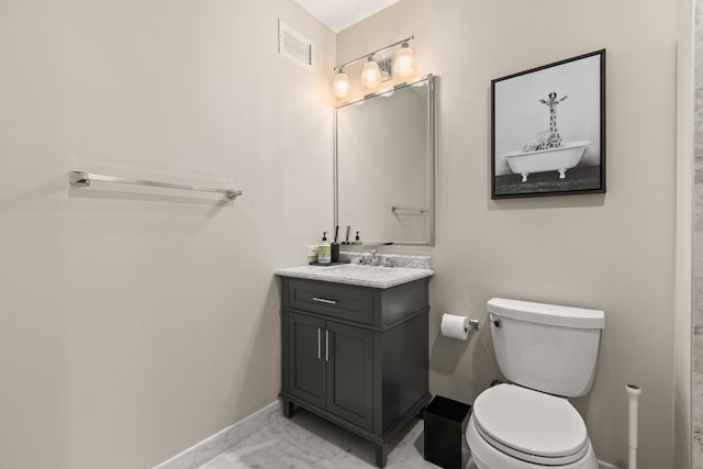 bathroom featuring vanity and toilet