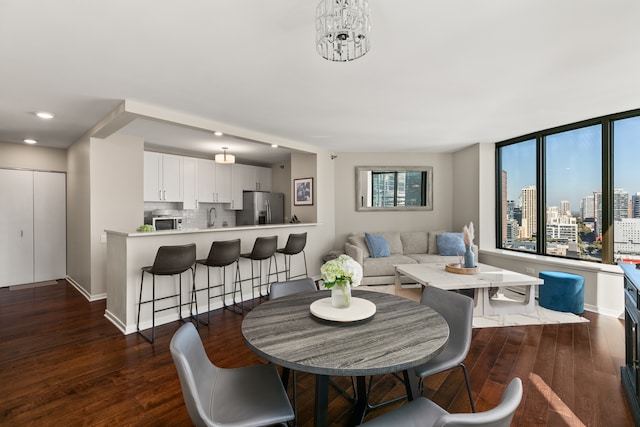 dining space with plenty of natural light, sink, and dark hardwood / wood-style flooring