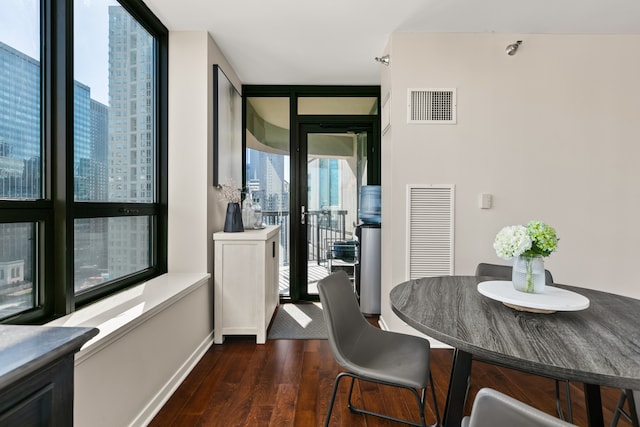 dining space featuring a wealth of natural light and dark hardwood / wood-style floors