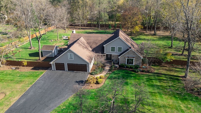 view of front of property with a front lawn and a garage