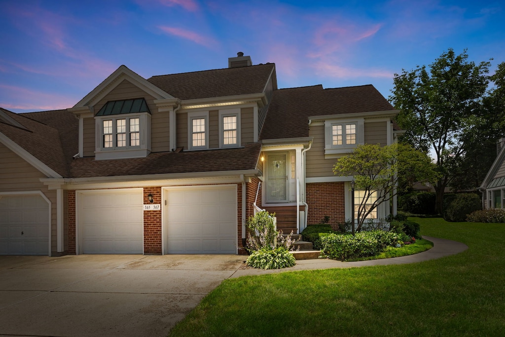 view of front facade featuring a lawn and a garage