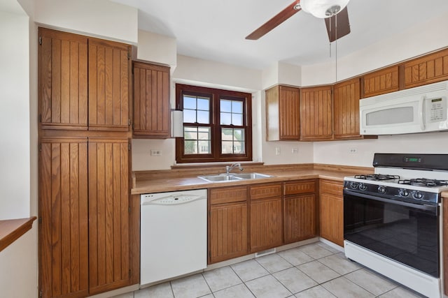 kitchen featuring white appliances, ceiling fan, light tile patterned floors, and sink