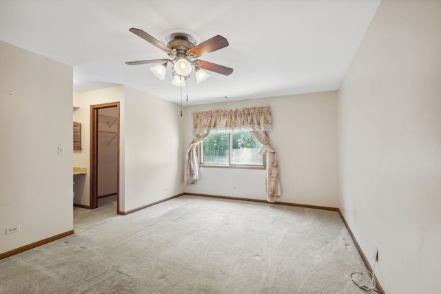 unfurnished room with light colored carpet and ceiling fan