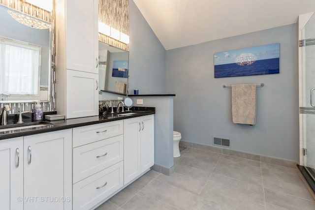 bathroom featuring lofted ceiling, vanity, an enclosed shower, and toilet