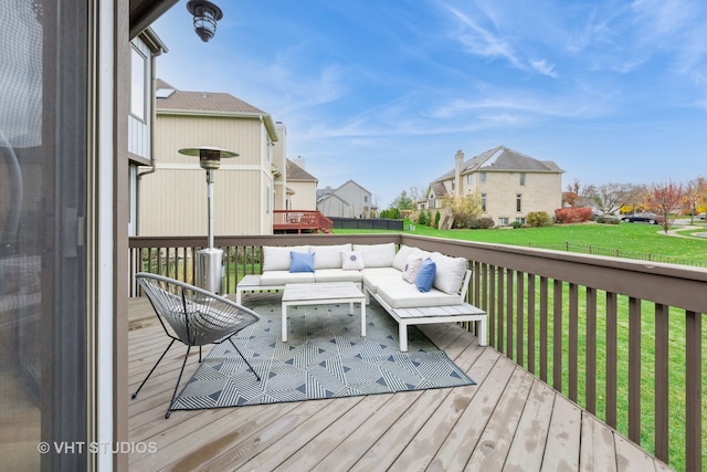 wooden deck featuring a lawn and an outdoor hangout area