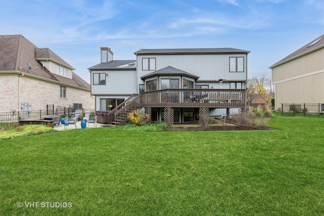 rear view of property with a deck and a yard