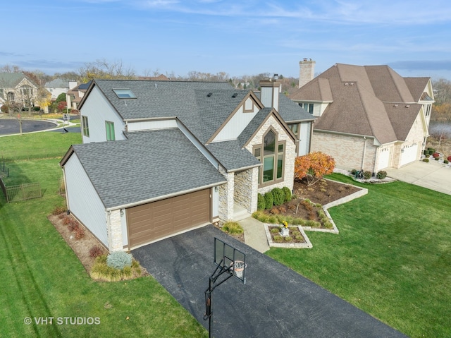 view of front of house featuring a garage and a front lawn