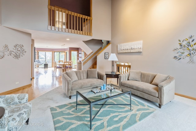 living room featuring wood-type flooring and a high ceiling