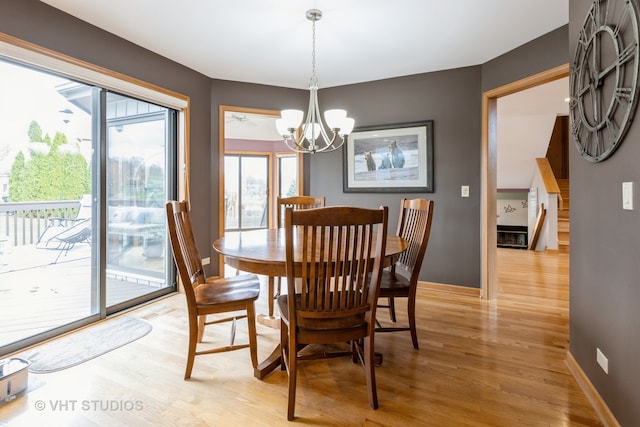 dining space featuring a notable chandelier and light hardwood / wood-style floors