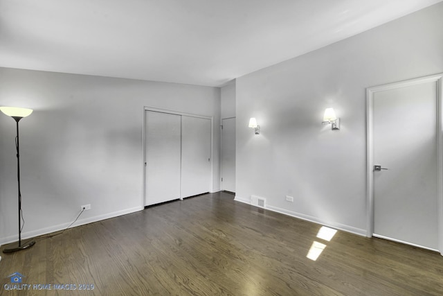 empty room with dark hardwood / wood-style floors