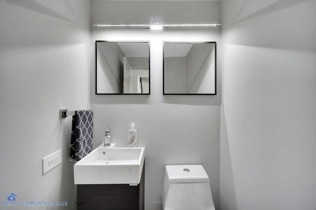 bathroom with vanity and toilet