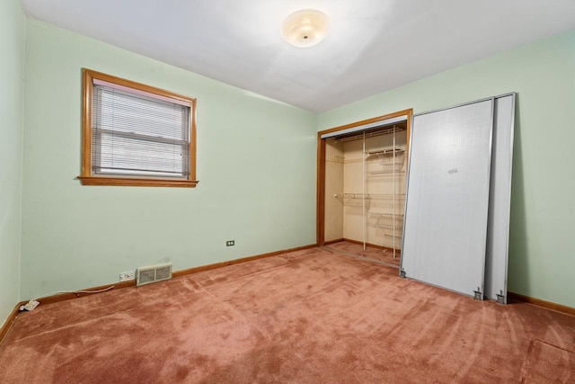 unfurnished bedroom with carpet flooring and a closet