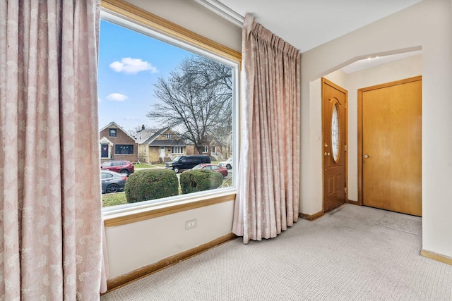 doorway to outside featuring carpet