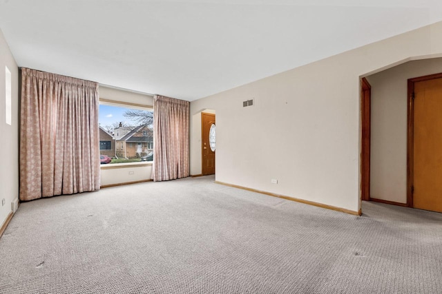 spare room featuring light colored carpet