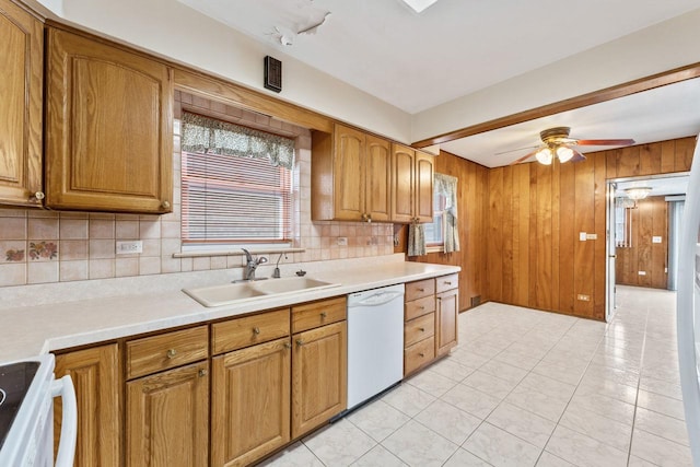 kitchen with dishwasher, range, light tile patterned floors, and sink