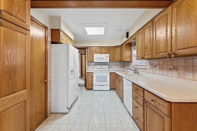 kitchen featuring white appliances, sink, light tile patterned floors, and tasteful backsplash