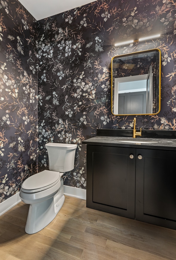 bathroom with hardwood / wood-style flooring, vanity, and toilet