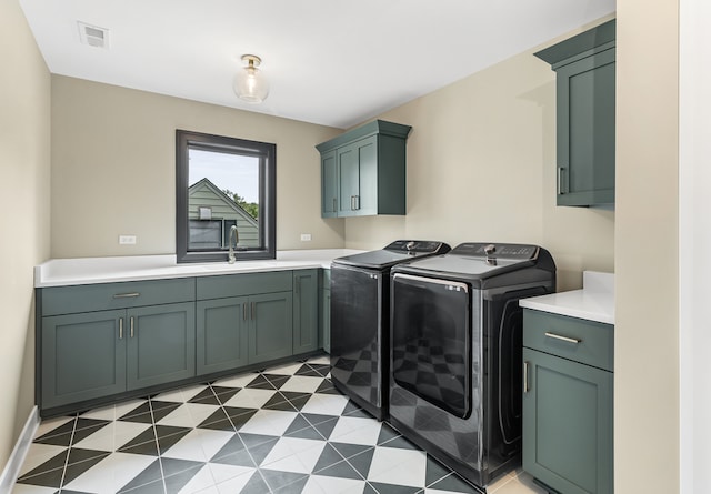 laundry area with cabinets, sink, and washer and dryer