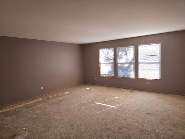 spare room featuring light colored carpet