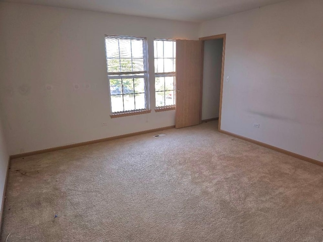 spare room with light carpet