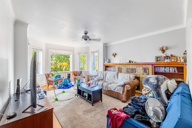 living room with hardwood / wood-style flooring, crown molding, and ceiling fan