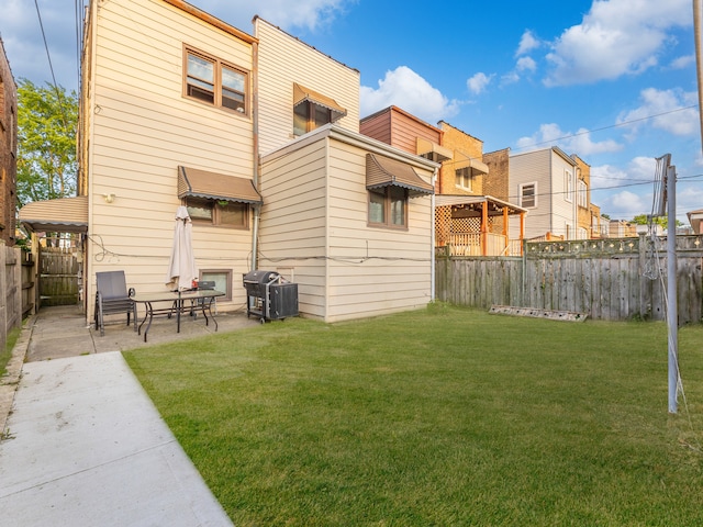 back of property featuring a patio and a lawn