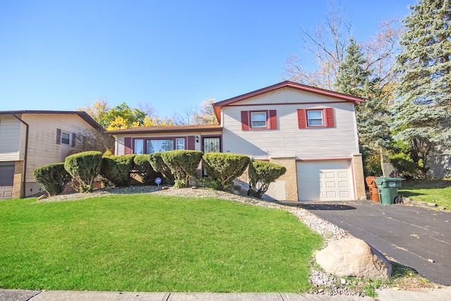 split level home featuring a garage and a front yard