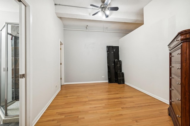 interior space with a textured ceiling, light hardwood / wood-style floors, and ceiling fan