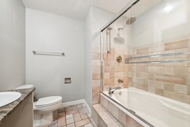 full bathroom featuring tile patterned floors, vanity, toilet, and bath / shower combo with glass door