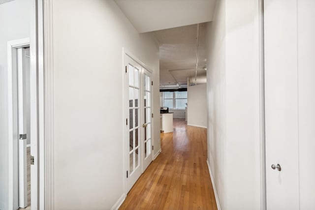 hallway with light hardwood / wood-style flooring