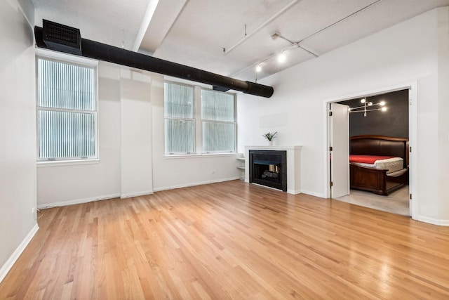 unfurnished living room with light wood-type flooring