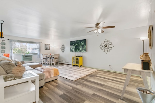 living room featuring a baseboard radiator, hardwood / wood-style floors, ceiling fan, and cooling unit