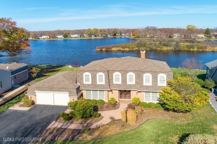 birds eye view of property with a water view