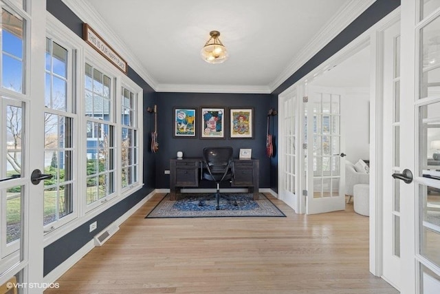 office space featuring french doors, crown molding, and light hardwood / wood-style flooring