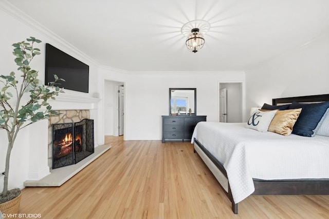 bedroom with hardwood / wood-style floors and ornamental molding