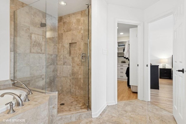 bathroom featuring independent shower and bath