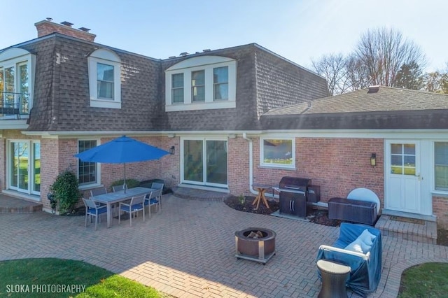 back of house with a patio area and an outdoor fire pit