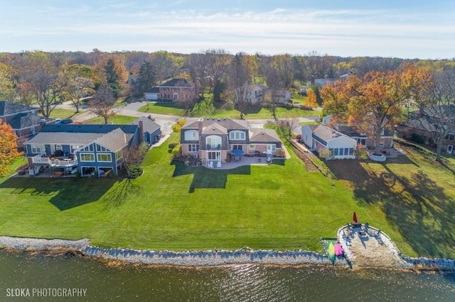 birds eye view of property with a water view