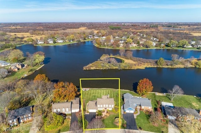 birds eye view of property with a water view