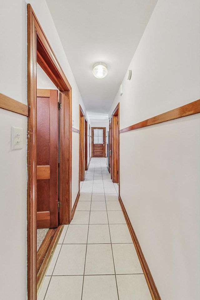 hall with light tile patterned floors