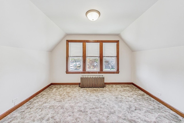 bonus room with carpet, radiator heating unit, and lofted ceiling