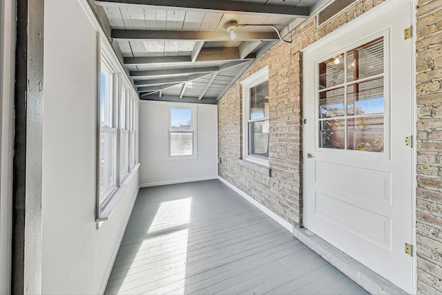 unfurnished sunroom featuring vaulted ceiling with beams and wooden ceiling