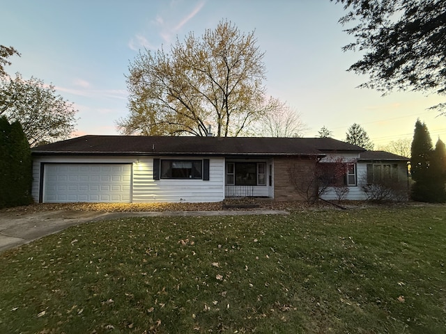 single story home featuring a yard and a garage